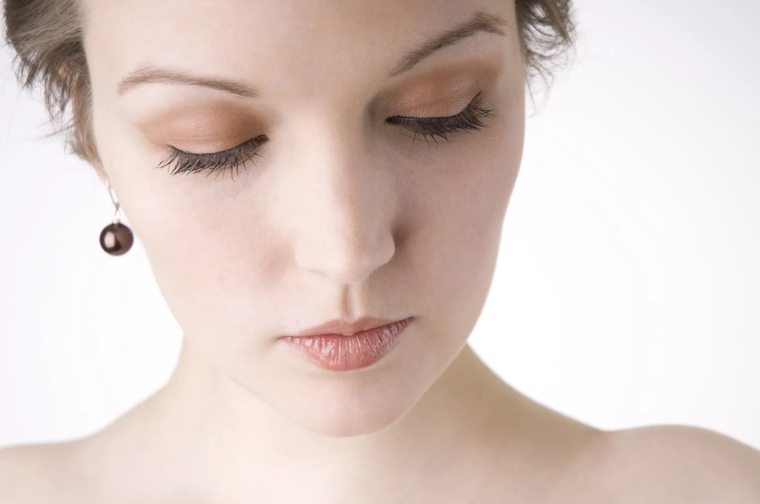 A woman with her eyes closed, suggesting a fearful or guarded emotional state